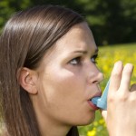 Young girl with asthma inhaler